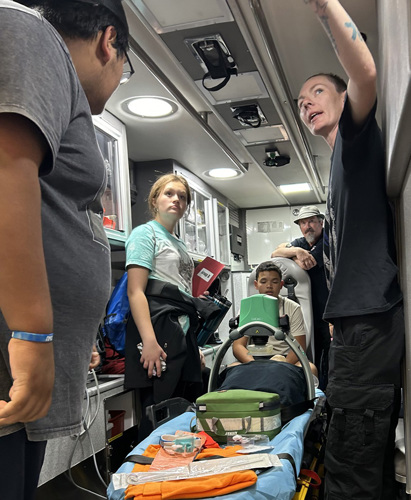 Scrubs Camp participants exploring an ambulance