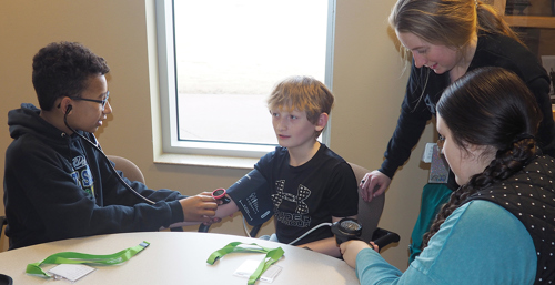 Camp Med students learning to take each others blood pressure.